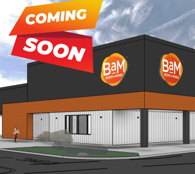 Rendering of a modern commercial building with 'Coming Soon' banners displayed